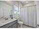 Clean bathroom featuring a shower, toilet, vanity with sink and mirror, and a window for natural light at 175 Darby Meadow Ln, Ridgeville, SC 29472