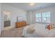 Bright bedroom with a large window, neutral carpet, and a bathroom ensuite for comfortable living at 175 Darby Meadow Ln, Ridgeville, SC 29472