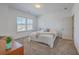 Cozy bedroom with neutral carpet, a window with blinds, and a decorative throw blanket on the bed at 175 Darby Meadow Ln, Ridgeville, SC 29472