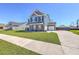 Charming two-story home with manicured lawn, stone accents, and a convenient two-car garage at 175 Darby Meadow Ln, Ridgeville, SC 29472