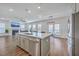 Modern kitchen with an island, stainless steel appliances, hardwood floors and an open layout to the living room at 175 Darby Meadow Ln, Ridgeville, SC 29472