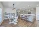 Open-concept kitchen with gray cabinets, stainless appliances, and a dining area with a modern light fixture at 175 Darby Meadow Ln, Ridgeville, SC 29472