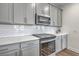 Stylish kitchen featuring white cabinets, subway tile backsplash, quartz countertops, and modern appliances at 175 Darby Meadow Ln, Ridgeville, SC 29472