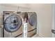 Convenient laundry room featuring side-by-side washer and dryer and wire shelving for optimal organization at 175 Darby Meadow Ln, Ridgeville, SC 29472