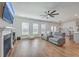 Open-concept living room with a fireplace, hardwood floors, and lots of natural light at 175 Darby Meadow Ln, Ridgeville, SC 29472