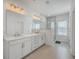 Modern main bathroom featuring dual sinks, white cabinets, and a separate glass-enclosed shower at 175 Darby Meadow Ln, Ridgeville, SC 29472