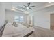 Bright main bedroom featuring a tray ceiling, neutral carpet, and an ensuite bathroom at 175 Darby Meadow Ln, Ridgeville, SC 29472