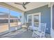 Relaxing screened-in patio with wicker chair and a rocking chair for comfortable outdoor lounging at 175 Darby Meadow Ln, Ridgeville, SC 29472