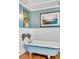 Stylish bathroom with a clawfoot tub, wainscoting, and light blue walls at 1808 Ion Ave, Sullivans Island, SC 29482