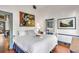 Cozy bedroom with an abstract painting, white bedding, and colorful decor at 1808 Ion Ave, Sullivans Island, SC 29482