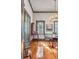 Inviting dining room features hardwood floors, an antique secretary, and chandelier at 1808 Ion Ave, Sullivans Island, SC 29482