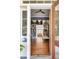 Welcoming entryway showcasing hardwood floors, built-in bookshelves, and stylish decor elements at 1808 Ion Ave, Sullivans Island, SC 29482