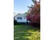 Charming home with a lush green lawn, vibrant pink flowers, and crisp white siding; perfect for serene living at 1808 Ion Ave, Sullivans Island, SC 29482