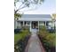 Inviting home with a lovely garden path leading to a charming entrance, framed by lush greenery and flowers at 1808 Ion Ave, Sullivans Island, SC 29482