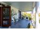 Spacious front porch with blue accents and views of the surrounding garden at 1808 Ion Ave, Sullivans Island, SC 29482