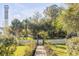 Inviting front yard with mature trees, lush greenery, and a charming picket fence leading to the property at 1808 Ion Ave, Sullivans Island, SC 29482
