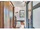 Hallway with wood floors and shiplap walls, accented with a unique mermaid wall hanging at 1808 Ion Ave, Sullivans Island, SC 29482