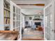 Cozy living room with French doors, a fireplace, and built-in bookshelves at 1808 Ion Ave, Sullivans Island, SC 29482