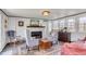 Living room featuring a brick fireplace, striped chairs, and a zebra-print rug at 1808 Ion Ave, Sullivans Island, SC 29482