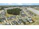 Panoramic aerial view of a residential community with a lake, lush green spaces, and tree lined streets at 182 Callibluff Dr, Summerville, SC 29486