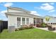 Charming backyard with green lawn, landscaped garden beds, and a cozy patio area with chairs for relaxation at 182 Callibluff Dr, Summerville, SC 29486