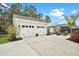 Wide driveway leads to a two-car garage and outdoor space with seating area in the well-maintained backyard at 182 Callibluff Dr, Summerville, SC 29486