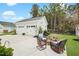 Spacious backyard featuring a two-car garage and a charming patio area with seating for outdoor relaxation at 182 Callibluff Dr, Summerville, SC 29486