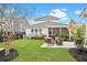 Lush backyard with well-manicured lawn, cozy seating area, and vibrant landscaping, perfect for outdoor gatherings at 182 Callibluff Dr, Summerville, SC 29486