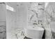 Modern bathroom showcasing a freestanding tub, marble flooring, and a glass-enclosed shower at 182 Callibluff Dr, Summerville, SC 29486