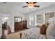 Well-lit primary bedroom featuring hardwood floors, plantation shutters, and ample storage at 182 Callibluff Dr, Summerville, SC 29486