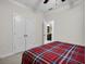 Comfortable bedroom with carpet and a bed featuring a red plaid comforter; ensuite bathroom is visible at 182 Callibluff Dr, Summerville, SC 29486