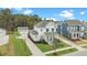 Two-story home featuring light blue shutters, a welcoming porch, lush lawn, and detached garage at 182 Callibluff Dr, Summerville, SC 29486
