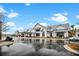 Modern community building with white siding, metal roof, and wet roads on a partly cloudy day at 182 Callibluff Dr, Summerville, SC 29486