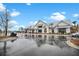 Modern community building with white siding, metal roof, and wet roads on a partly cloudy day at 182 Callibluff Dr, Summerville, SC 29486