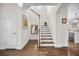 Welcoming foyer with wood floors, staircase, and bright, neutral tones at 182 Callibluff Dr, Summerville, SC 29486