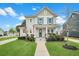 Charming two-story home with a manicured lawn, inviting front porch, and light-colored siding at 182 Callibluff Dr, Summerville, SC 29486