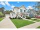 Two-story home with a manicured lawn and inviting front porch that enhances the home's curb appeal at 182 Callibluff Dr, Summerville, SC 29486