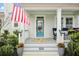 Inviting front porch with a bright blue door, potted plants, and comfortable seating, perfect for relaxing at 182 Callibluff Dr, Summerville, SC 29486