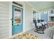 Charming front porch featuring comfortable seating and a bright blue door, creating a welcoming entrance at 182 Callibluff Dr, Summerville, SC 29486