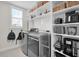 Functional laundry room with shelving, washer, dryer, and ample storage at 182 Callibluff Dr, Summerville, SC 29486