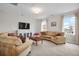 Bright living room with large windows, plush seating, and a modern entertainment center at 182 Callibluff Dr, Summerville, SC 29486