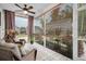 Cozy screened-in porch with wicker seating and view of the manicured garden and plants in the outdoor space at 182 Callibluff Dr, Summerville, SC 29486