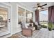 Comfortable screened porch with wicker chairs, patterned tile flooring, and serene outdoor views at 182 Callibluff Dr, Summerville, SC 29486