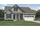 Charming home with a light green exterior, a two-car garage, and a well-manicured lawn at 2010 Riverbend Dr, Charleston, SC 29412