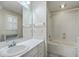 Well-lit bathroom with a large mirror, white vanity, and a combined shower and bathtub for convenience and functionality at 202 Crestwood Dr, Summerville, SC 29483