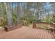 Spacious wooden deck area, surrounded by trees and featuring built-in seating, ideal for outdoor living at 202 Crestwood Dr, Summerville, SC 29483
