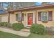 Inviting home exterior featuring a cozy front porch, lush landscaping, and charming details at 202 Crestwood Dr, Summerville, SC 29483