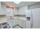 Bright kitchen with white cabinetry, light countertops, and stainless-steel appliances offers a clean, modern aesthetic at 202 Crestwood Dr, Summerville, SC 29483