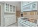 Open kitchen with white cabinetry and stainless-steel microwave with an eat-in breakfast bar overlooking the living room at 202 Crestwood Dr, Summerville, SC 29483
