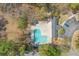 Aerial view of a community pool with sun deck and lounge chairs surrounded by lush greenery at 205 Yellow Hawthorn Cir, Summerville, SC 29483